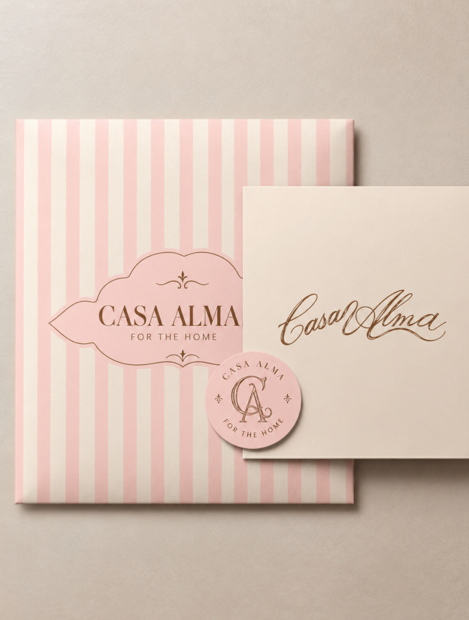 Hands opening a softly striped Casa Alma candle gift box
