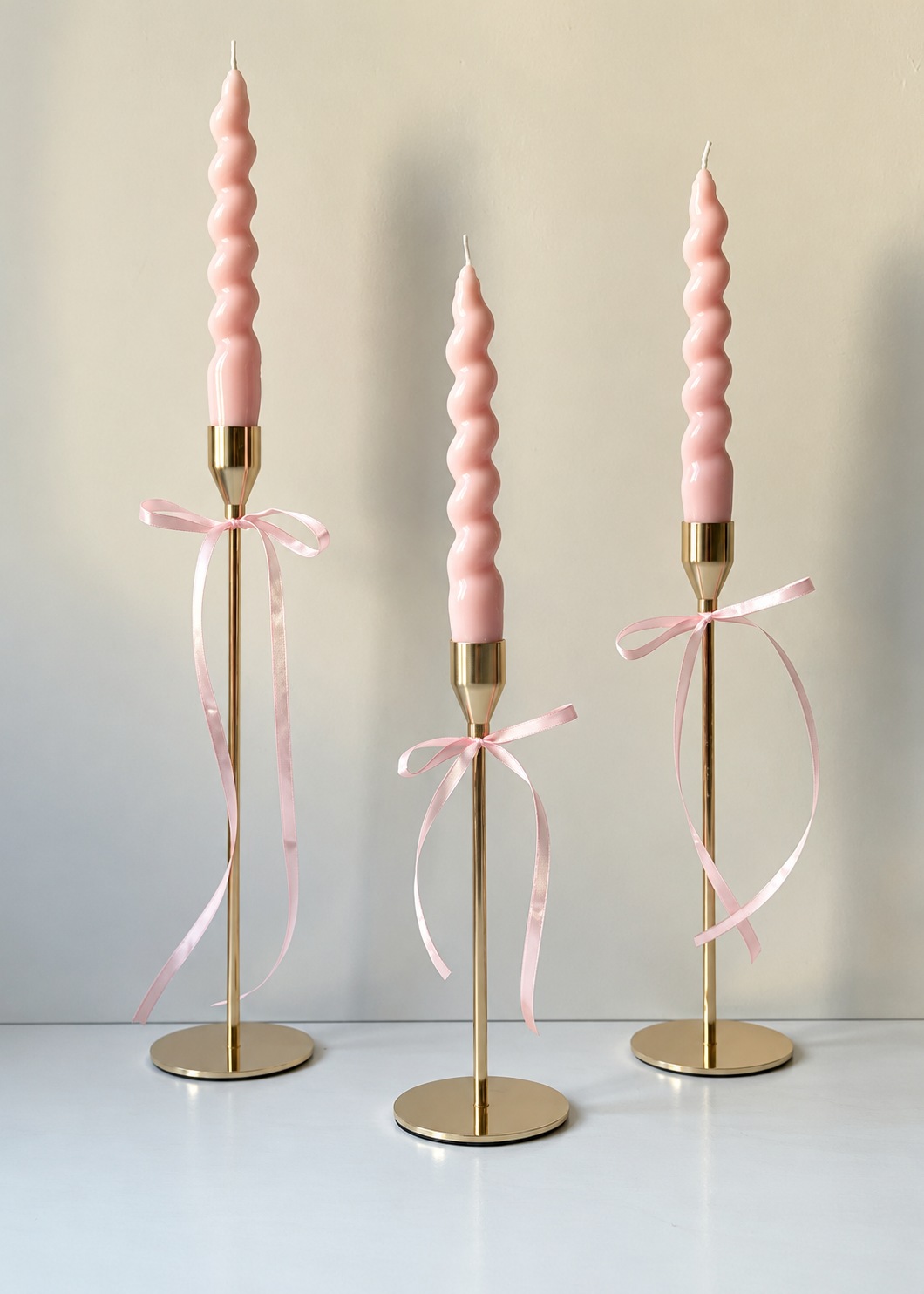 Two taper candles adorned with generous satin bows